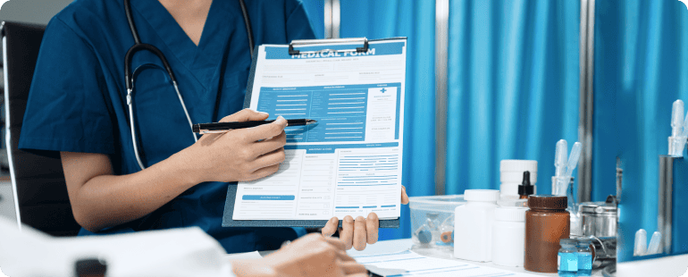 Nurse reviewing a medical form with a patient in a clinical setting.