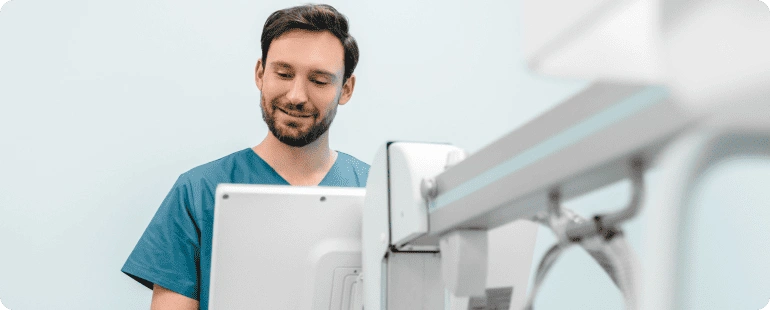 CT technologist operating a computed tomography scanner