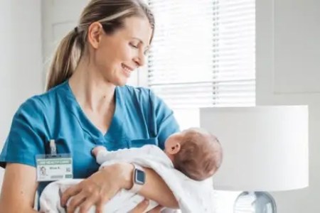 Labor and Delivery Nurse Holding Newborn Baby 450x300