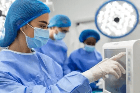 Cath Lab Tech Operating Cardiovascular Monitoring Equipment in Procedure Room 450x300