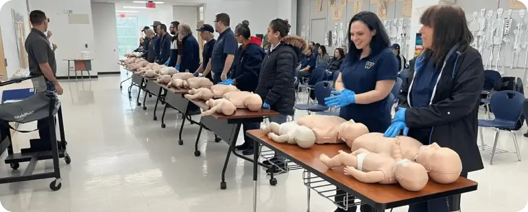 Healthcare providers practicing infant CPR during a BLS certification training session