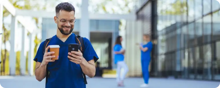 Travel allied health professional checking assignment details on his phone