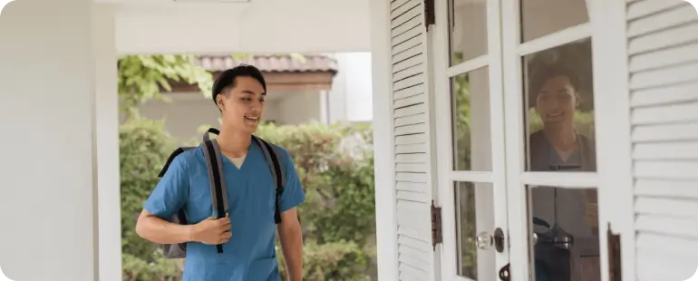Male travel nurse returning to his housing after a shift, highlighting flexible living options in travel nursing.