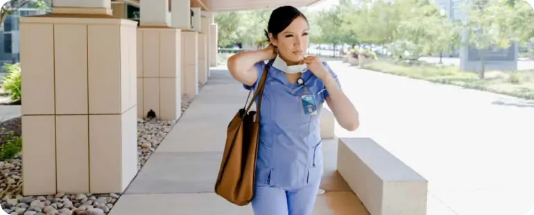 Female nurse walking to hospital building, representing best travel healthcare jobs for adventurous professionals