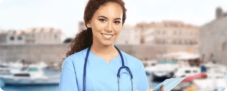 Travel nurse with required experience smiling near the harbor during assignment