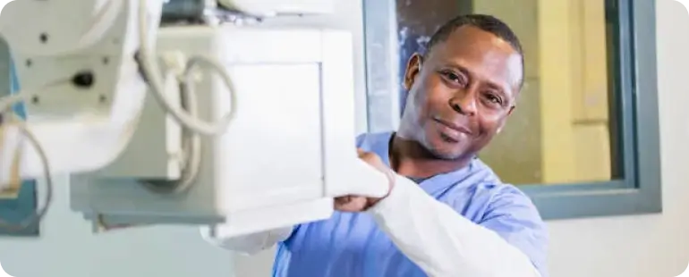 Travel Xray tech performing imaging procedure during hospital contract