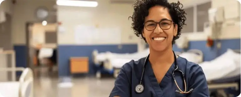 Travel nurse with active RN license standing in hospital after obtaining travel nurse license